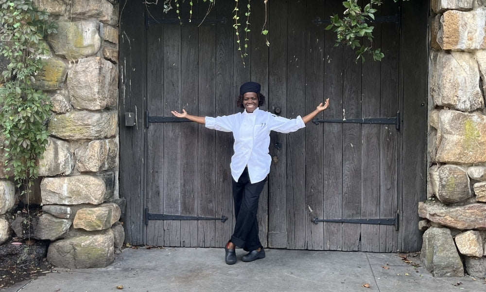 Eve dressed in her chef's uniform outdoors