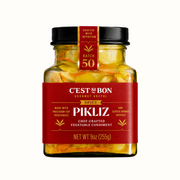 Jar of Spicy Pikliz with red label on a white background